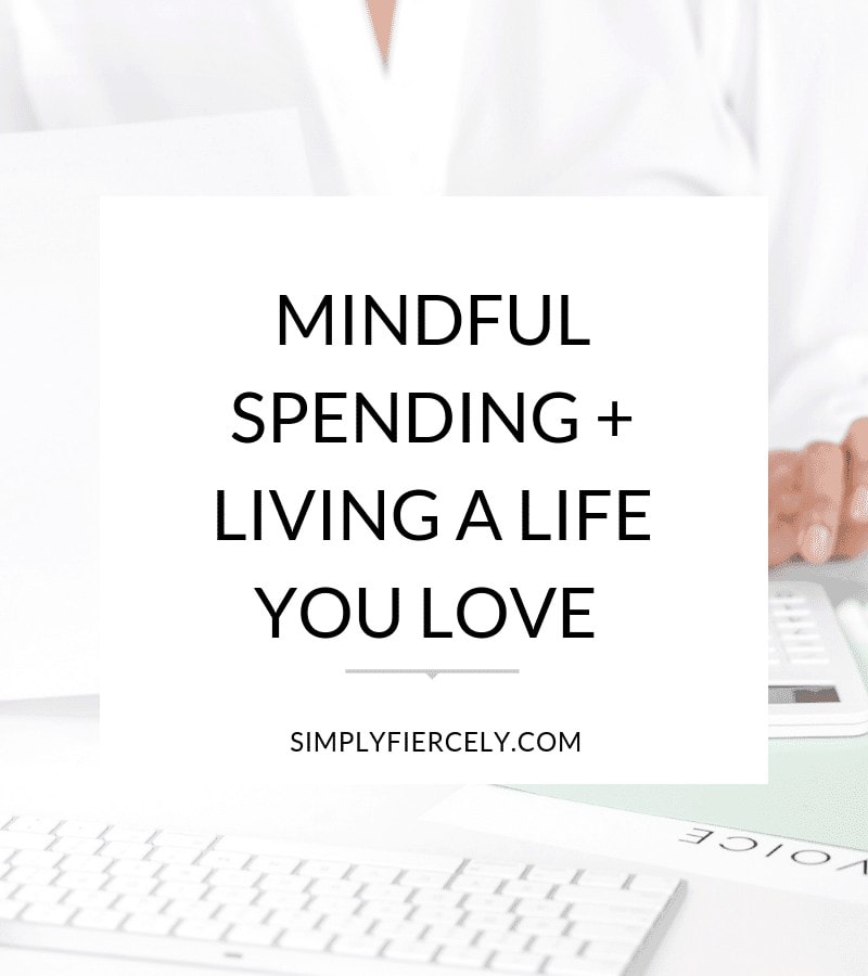 Text: "Mindful Spending  and Living a Life You Love" in the foreground with a woman using a calculator in the background. 