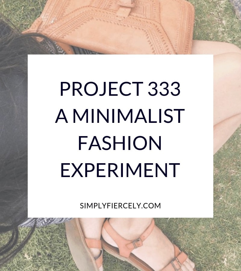 text: Project 333 A Minimalist Fashion Experiment in a white box with a girl kneeling on the grass in the background. 
