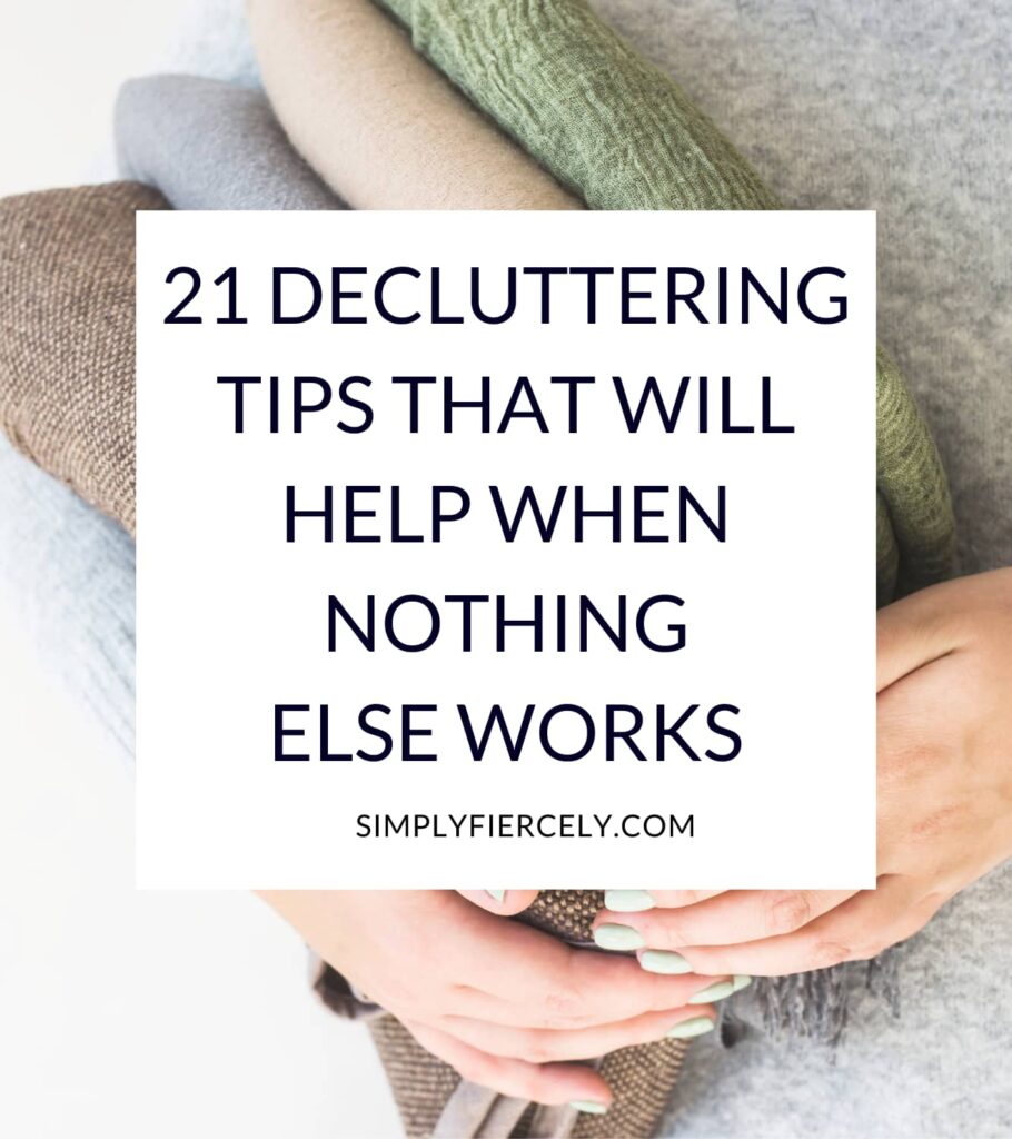 "21 Decluttering Tips That Will Help When Nothing Else Works" in a white box with a close up of woman holding a stack of folded sweaters in the background