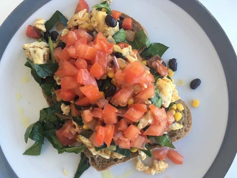 Here’s an example of a recent lunch—I had cleaned out the fridge (leftover black beans, tomatoes and spinach), added onions and frozen corn (staples) and served on toast!