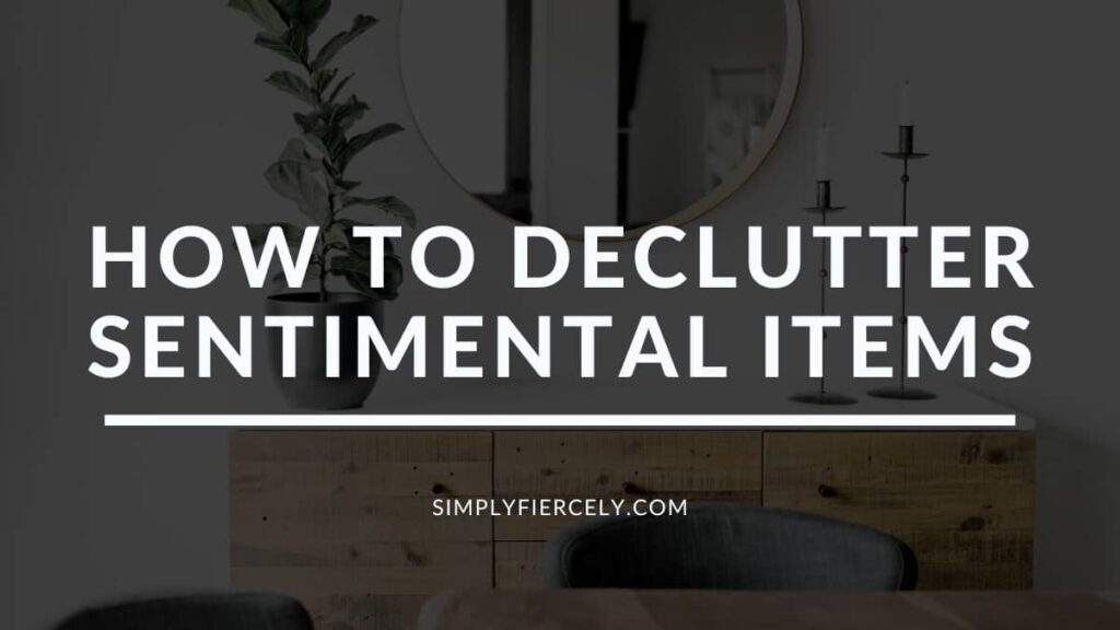 "How to Let Go of Sentimental Items While Decluttering" on a black background with an image of a wood buffet, a plant, candle holders, and a mirror in the background.