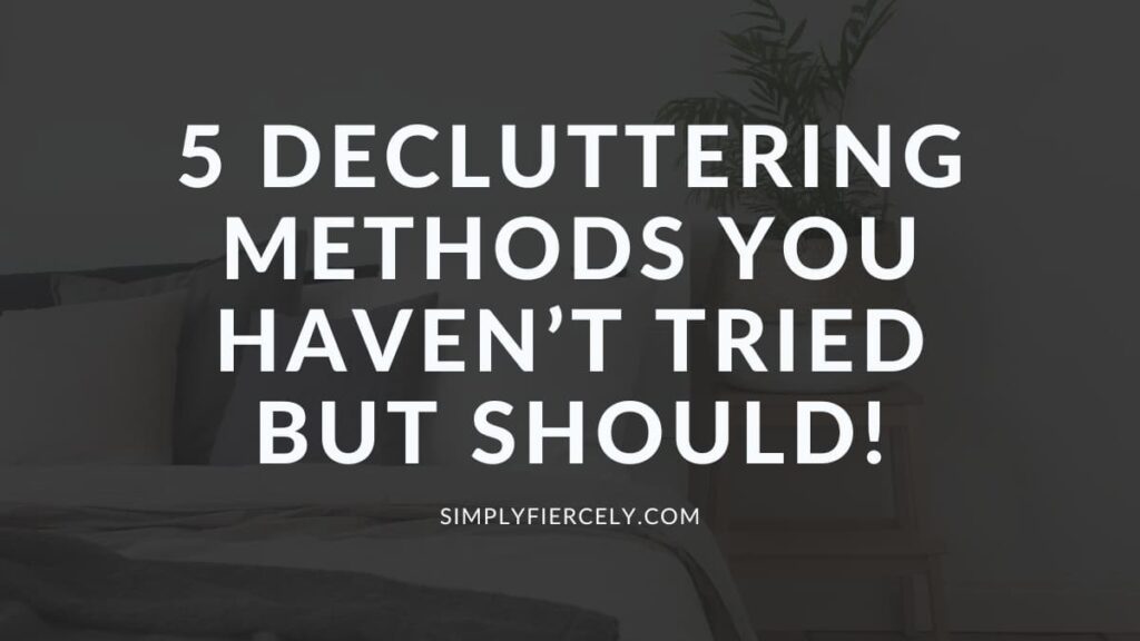 "5 Decluttering Methods You Haven't Tried But Should!" in white letters over a translucent black background on top of an image of a made bed with a plant on a wooden table.