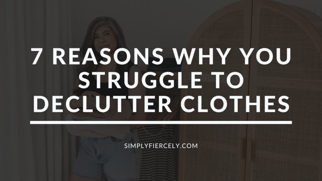 "7 Reasons Why You Struggle to Declutter Clothes" in white letters on a translucent black overlay on top of an image of a smiling woman wearing denim shorts and a black tank top decluttering her closet.