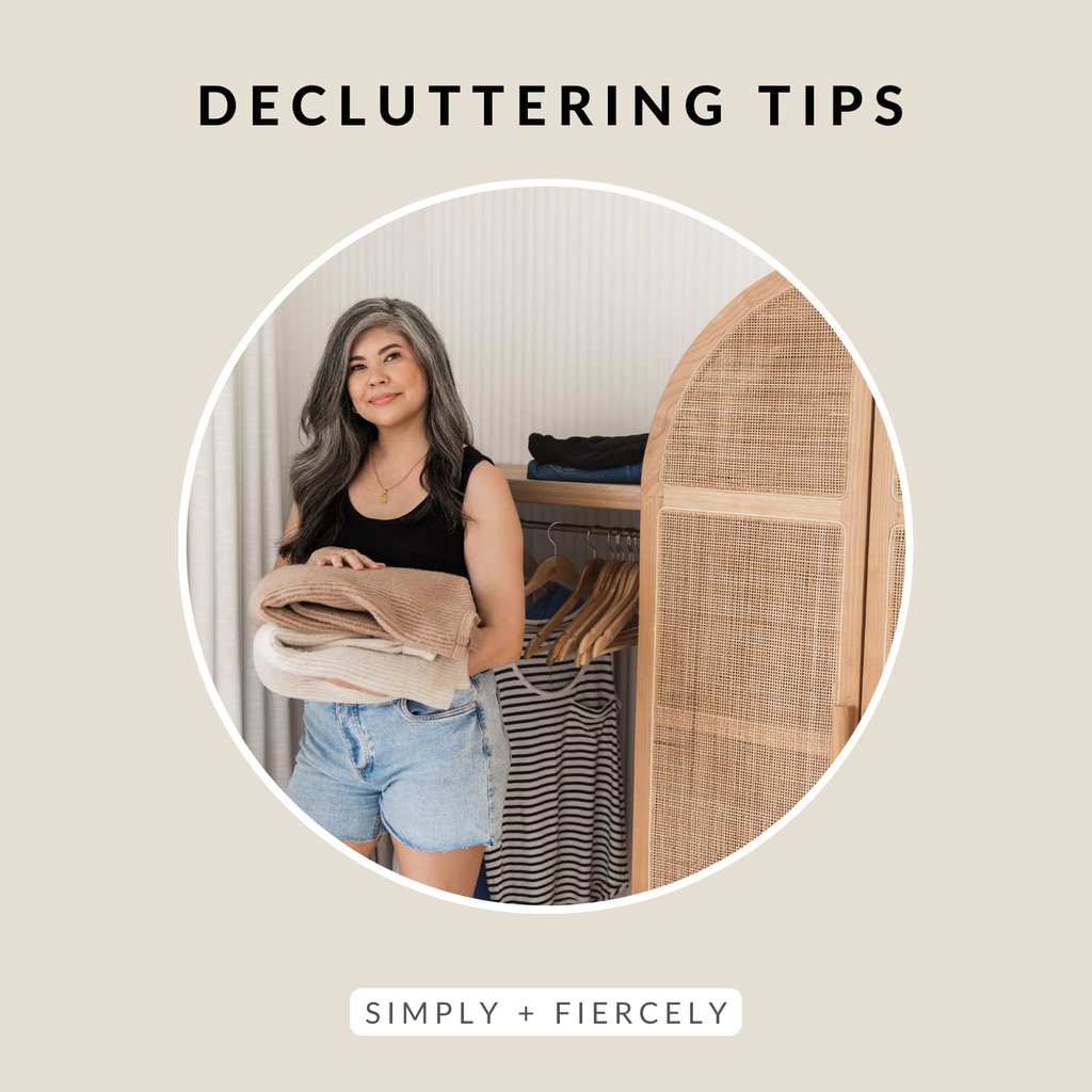A round image of a smiling woman wearing denim shorts and a black tank top decluttering her closet on a tan background with the words decluttering tips across the top.