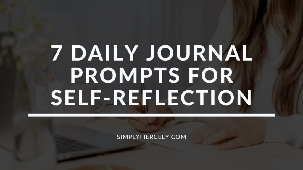 "7 Daily Journal Prompts For Self-Reflection" in white letters with a translucent black overlay on a close up image of a woman writing in an open journal.