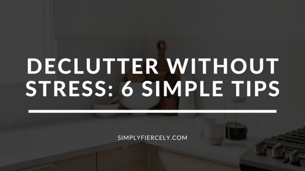 "Declutter Without Stress: 6 Simple Tips" in white letters on a translucent black overlay on an image of a kitchen with a cutting board, white bowl, coffee mugs and a french press on the counter