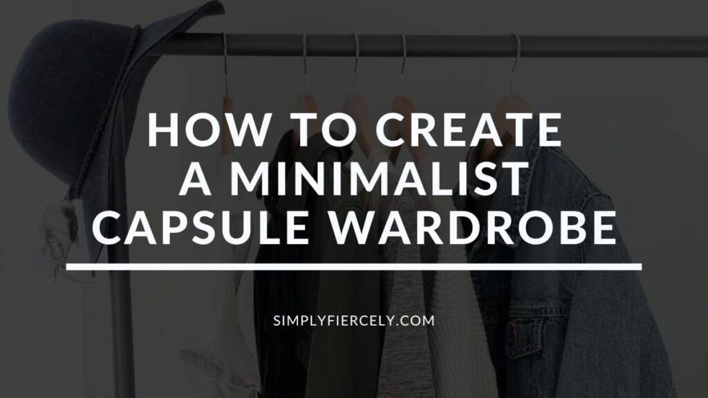 "How to Create a Minimalist Capsule Wardrobe (A Complete Guide)" in white letters on a translucent black overlay on top of an image of a clothes rack with sweaters and a denim jacket hanging on wooden hangers.