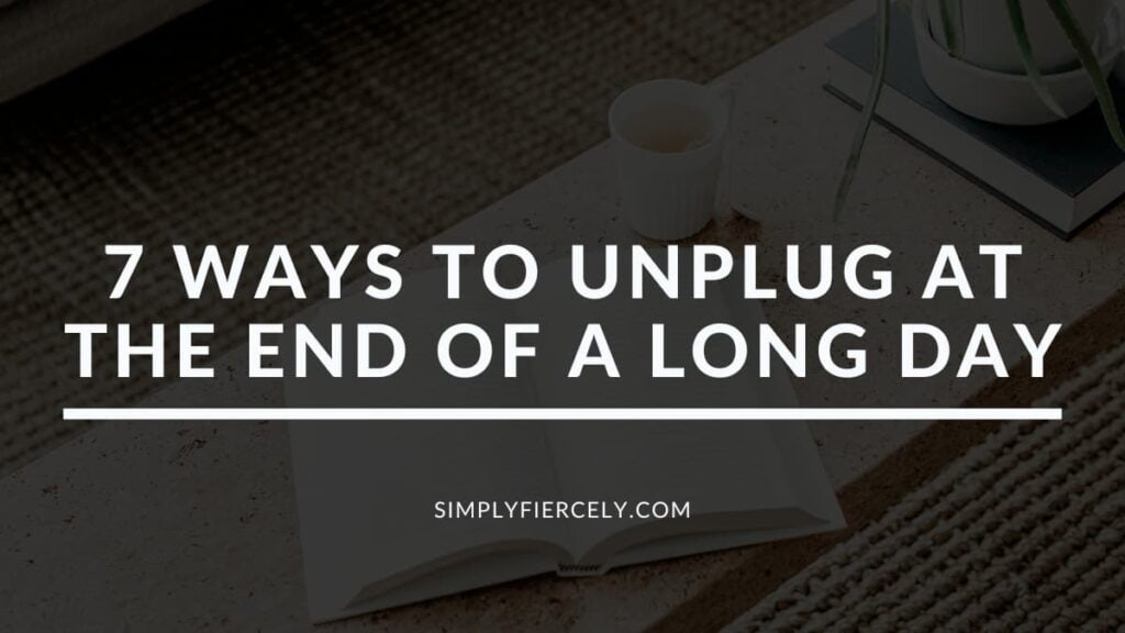"How to Disconnect 7 Ways to Unplug at the End of a Long Day" in white letters on a translucent black overlay on top of an image of a cement bench with an open book, a cup of teak and a plant on a woven rug.