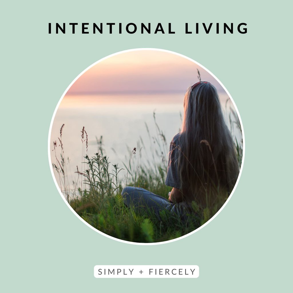 A round image of a woman sitting in the grass looking out at the water at sunset on a green background with the words Intentional Living across the top.