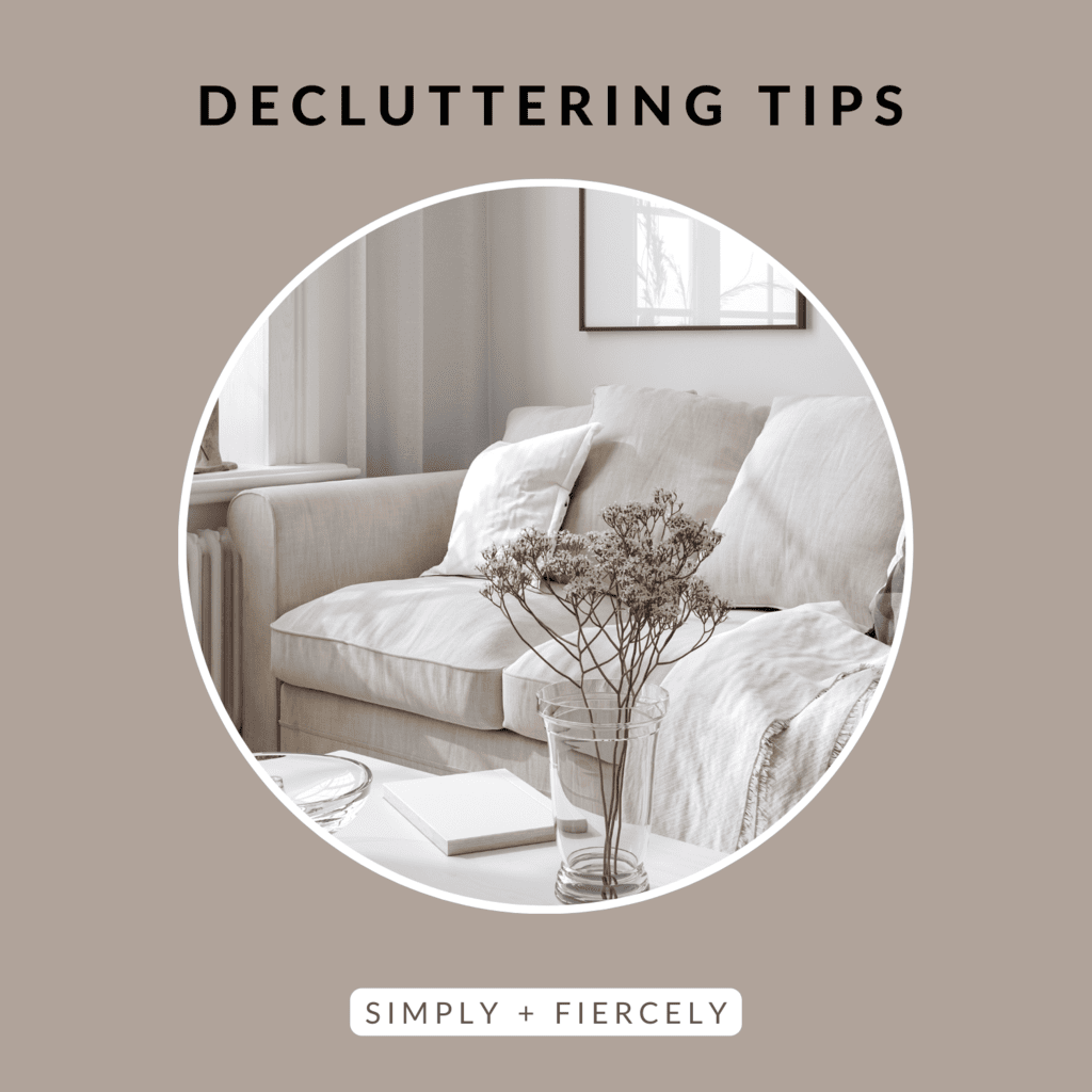 A round image of a white sofa with a vase of dried flowers in a minimalist home on a taupe background with the words Decluttering Tips across the top.
