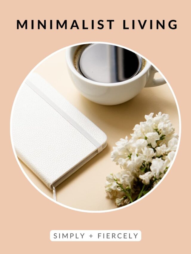 A round image of a white journal, coffee mug, keyboard, and white flowers on a wooden desk on an orange background with the words Minimalist Living across the top.